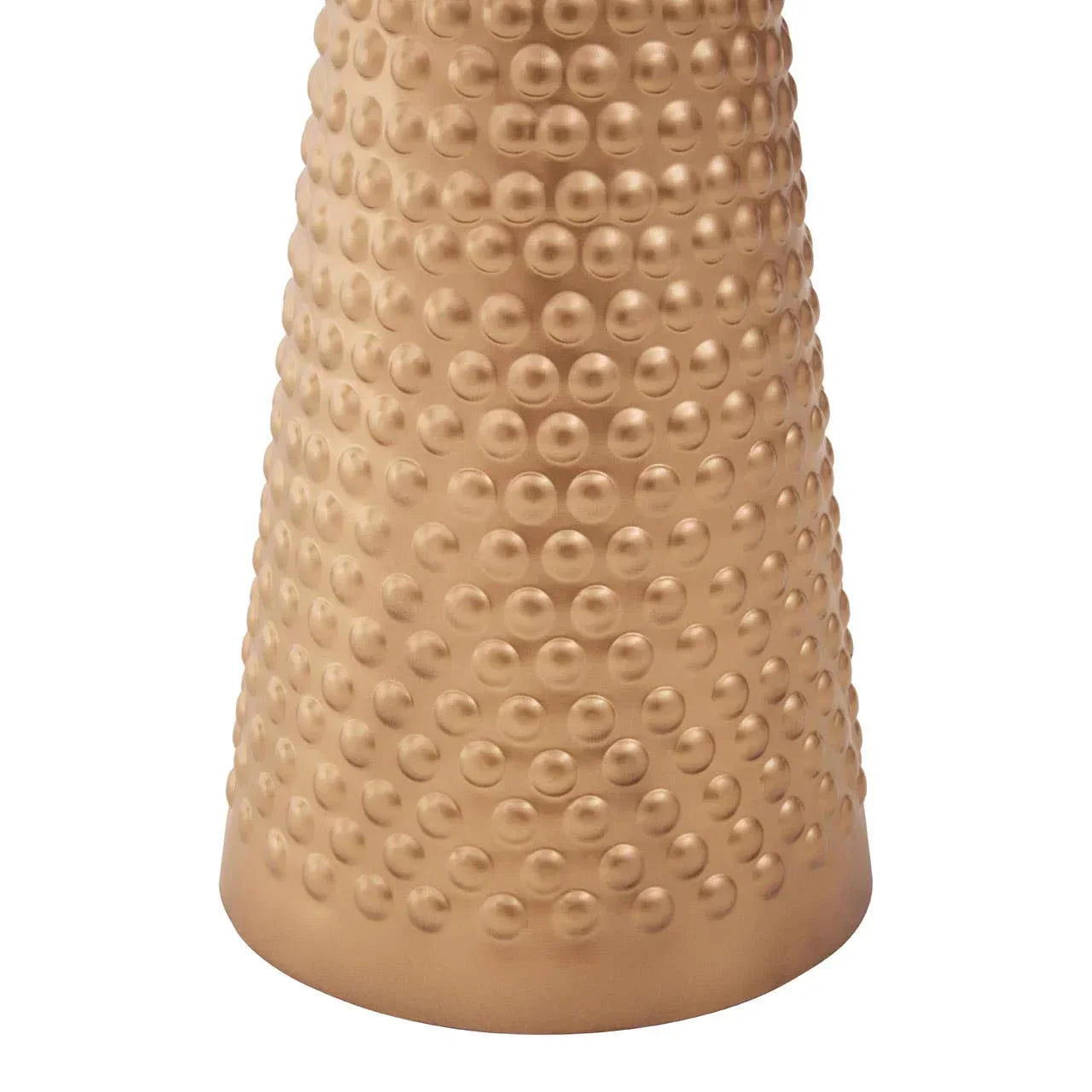 Gold textured metal vase base with raised dot pattern, close-up of decorative home accessory