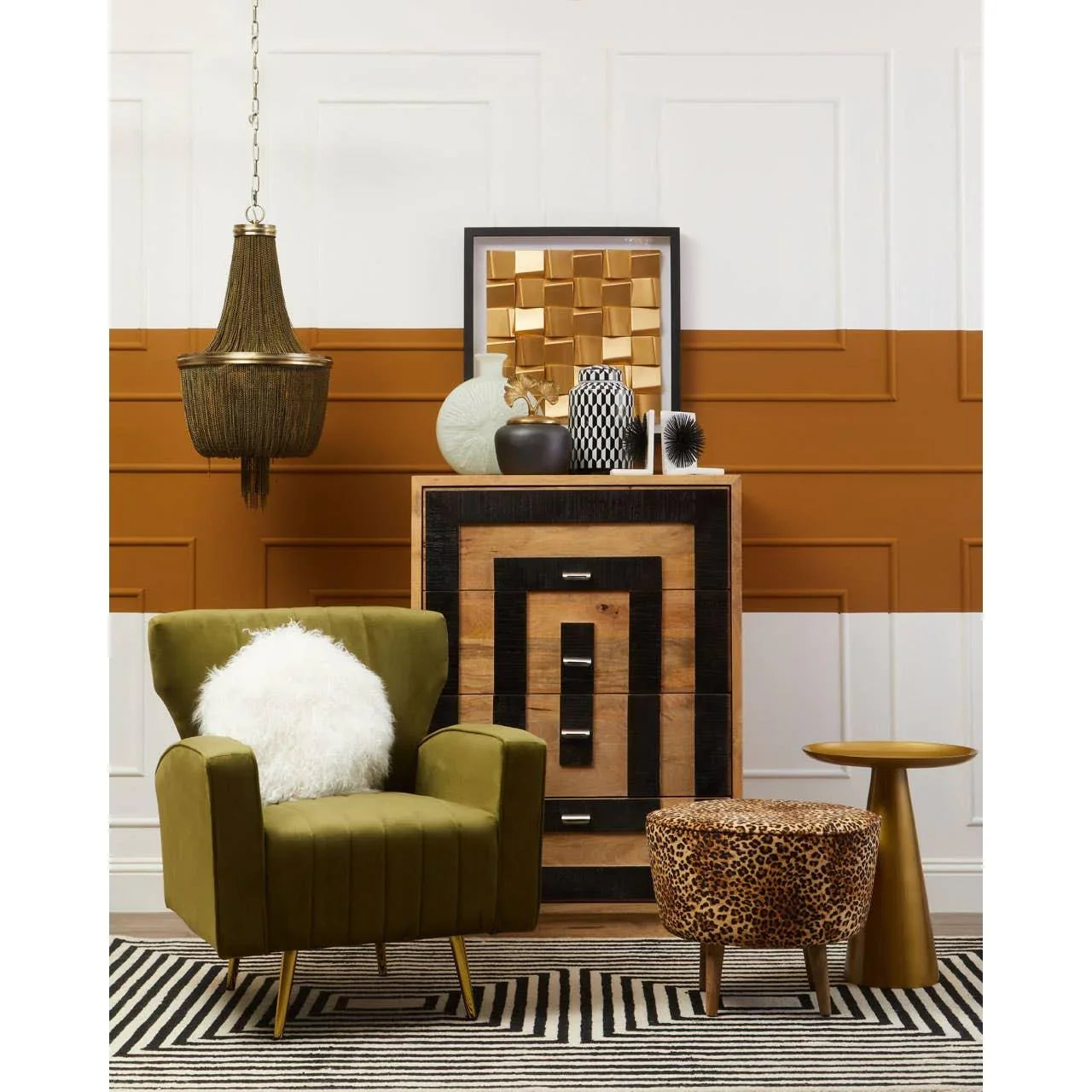 Olive green accent chair with white cushion, leopard print stool, wood chest, gold side table