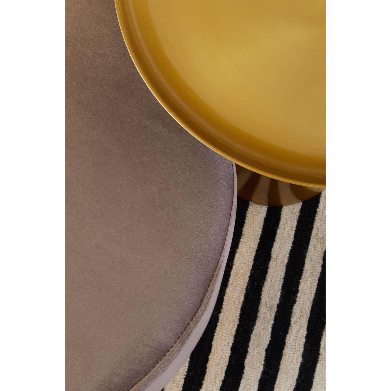 Velvet round ottoman and gold coffee table on black and white striped rug