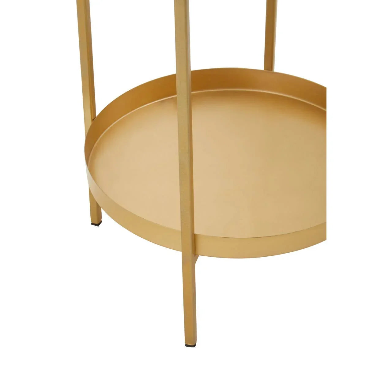 Round gold metal side table with lower shelf and slim legs, close-up view