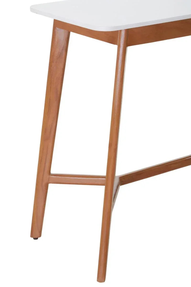 Detail of dining table with white top and angled wooden legs