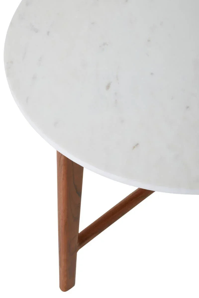Round white marble table top with wooden legs, closeup of furniture detail