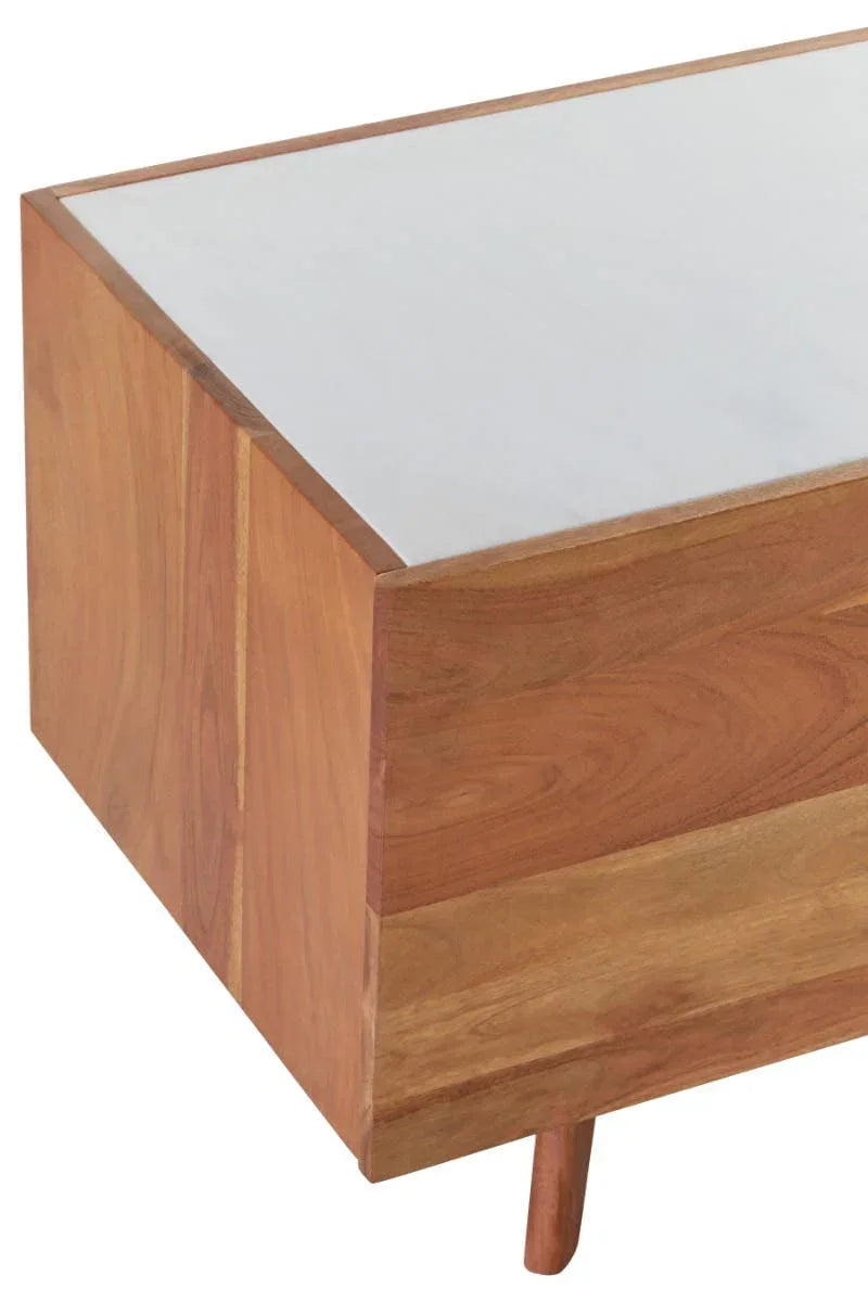 Corner view of wooden coffee table with white marble top and angled leg
