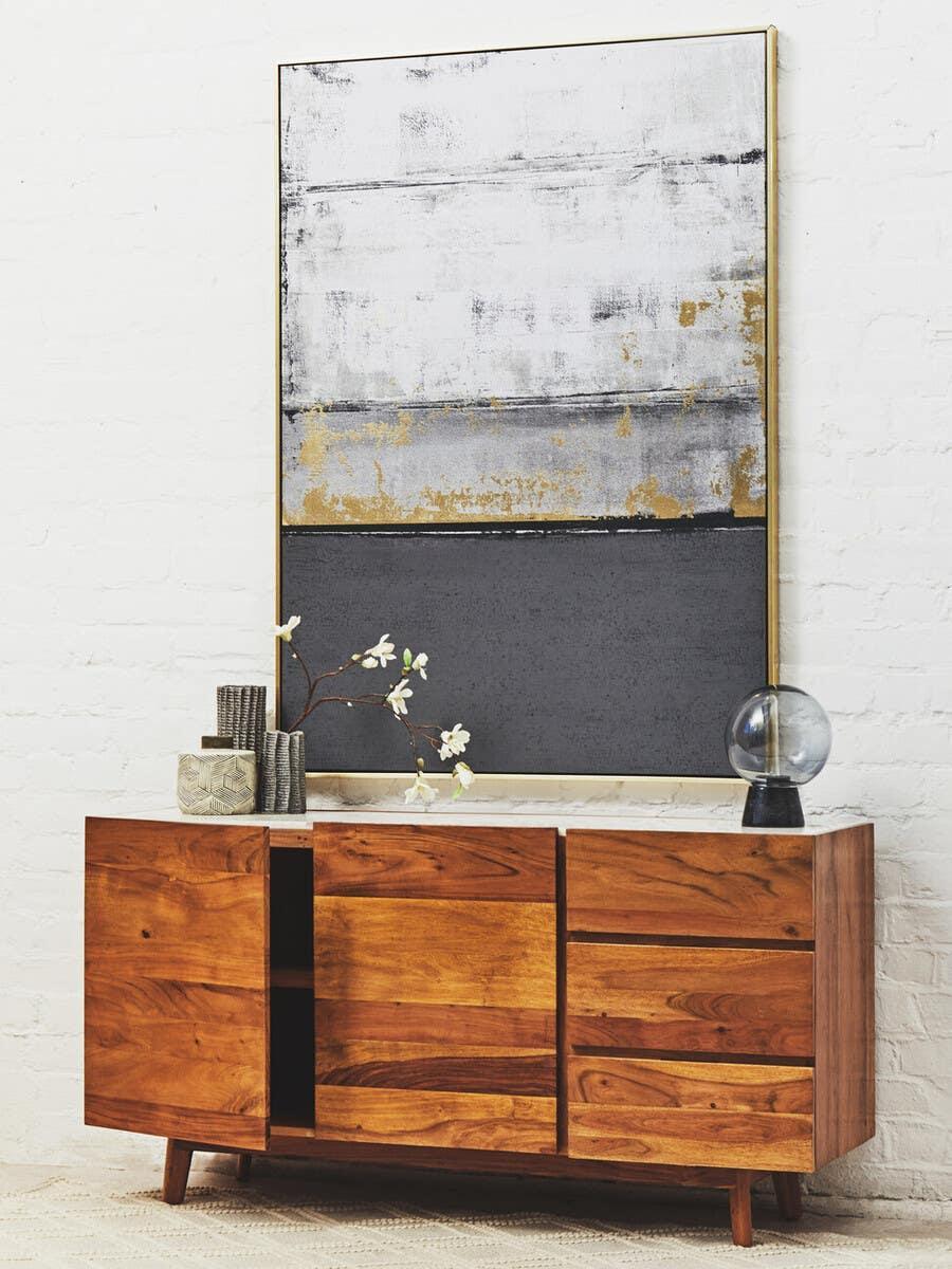 Solid wood sideboard with natural finish, abstract wall art, modern decor accents