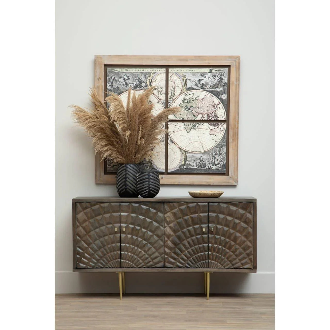 Carved wood sideboard with gold legs, decorative vase with pampas grass, vintage map art
