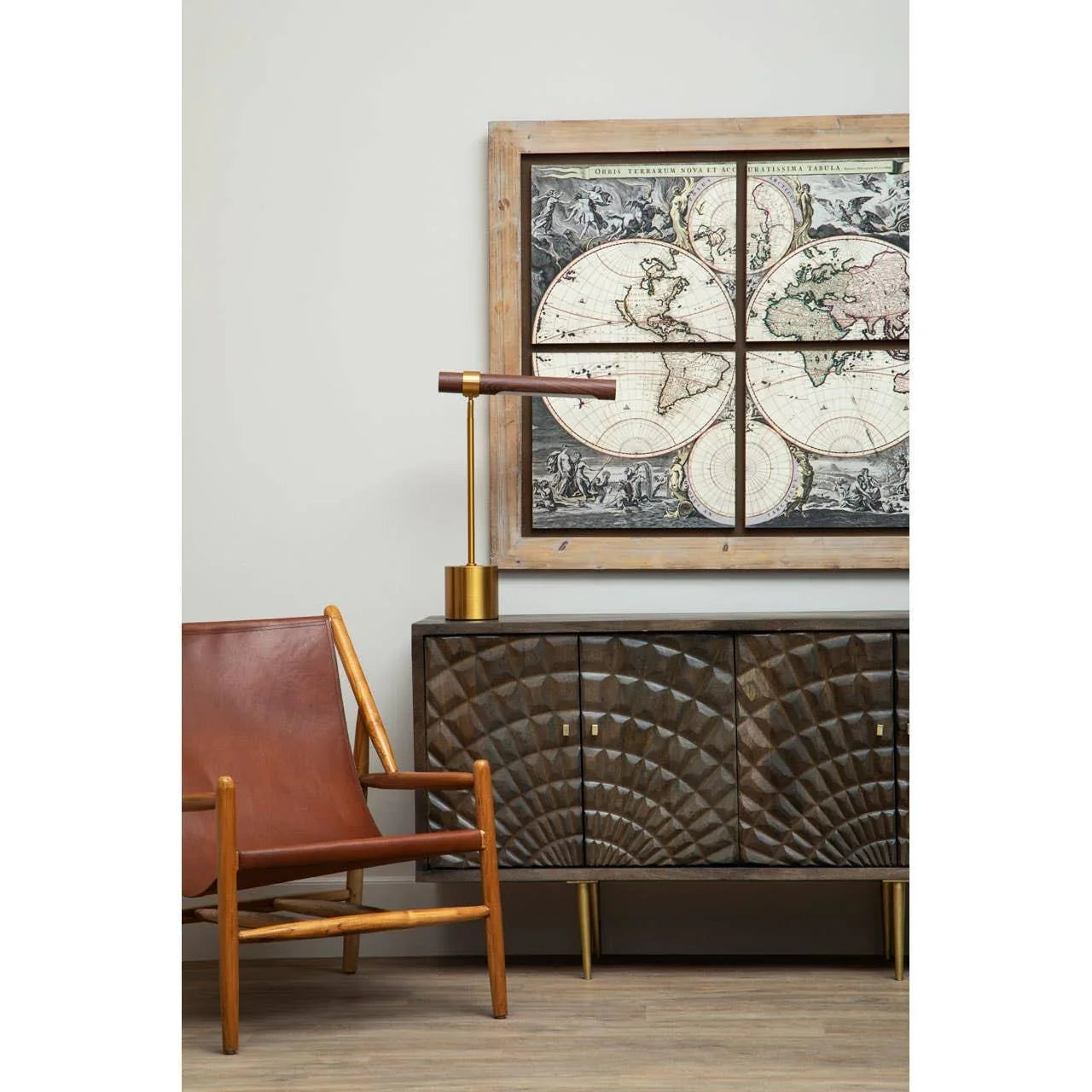 Dark wood sideboard with geometric pattern, leather accent chair, brass table lamp, vintage map