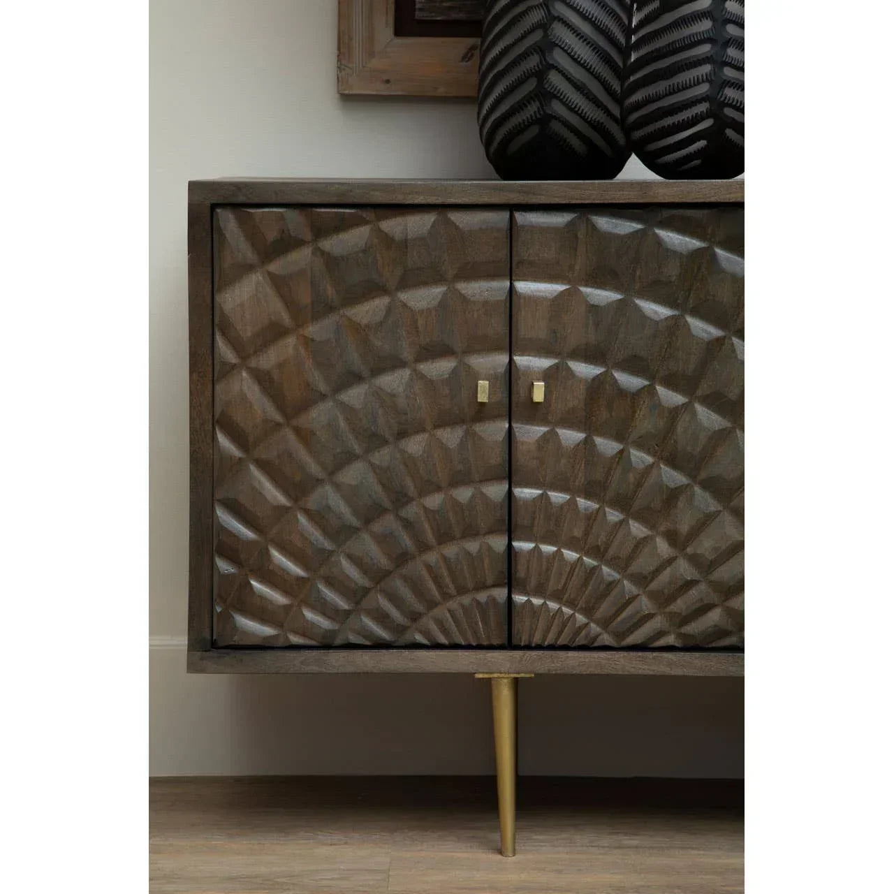 Carved wood sideboard with geometric pattern, gold handles and single gold leg