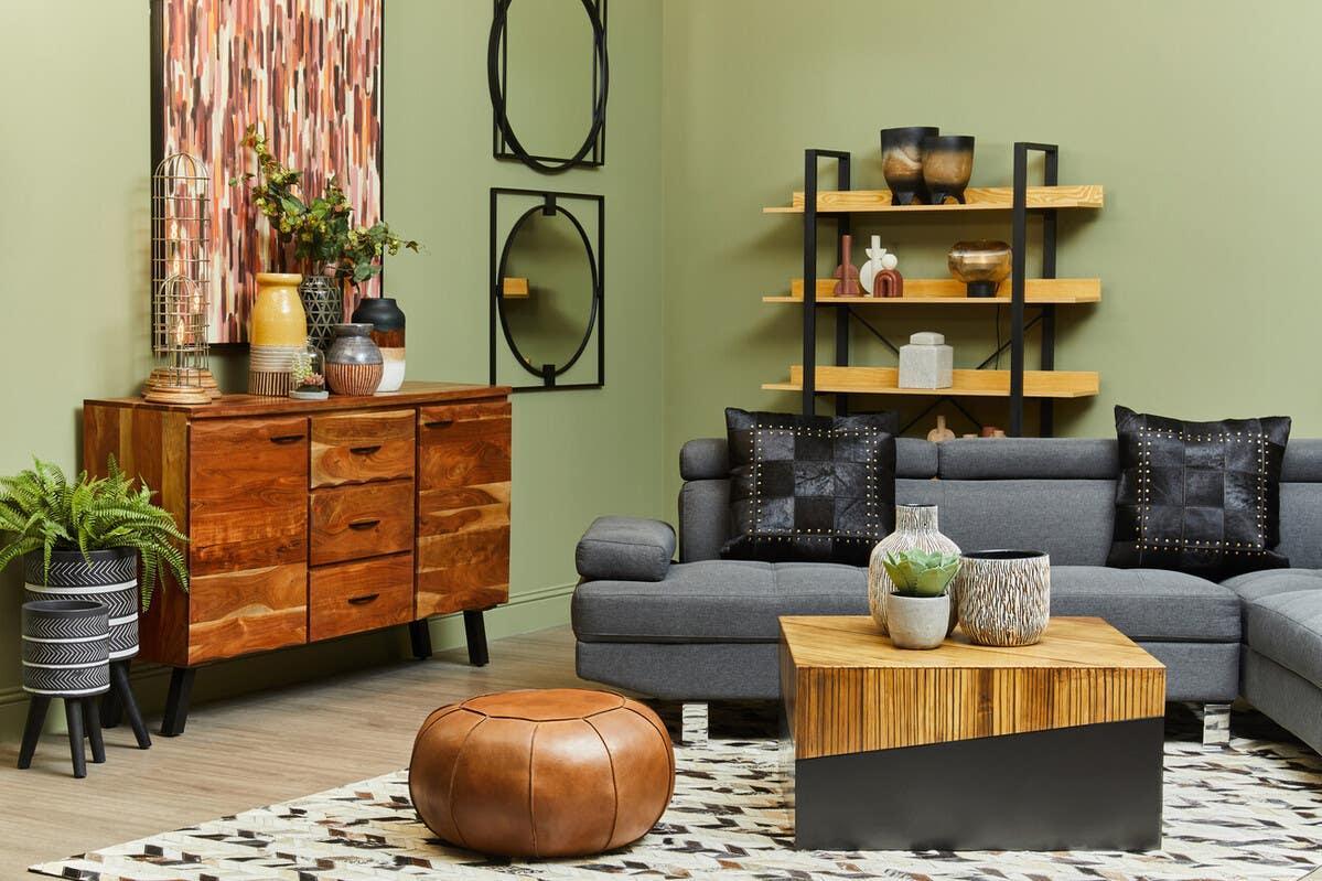 Modern living room with grey corner sofa, wooden coffee table, oak sideboard and shelving unit
