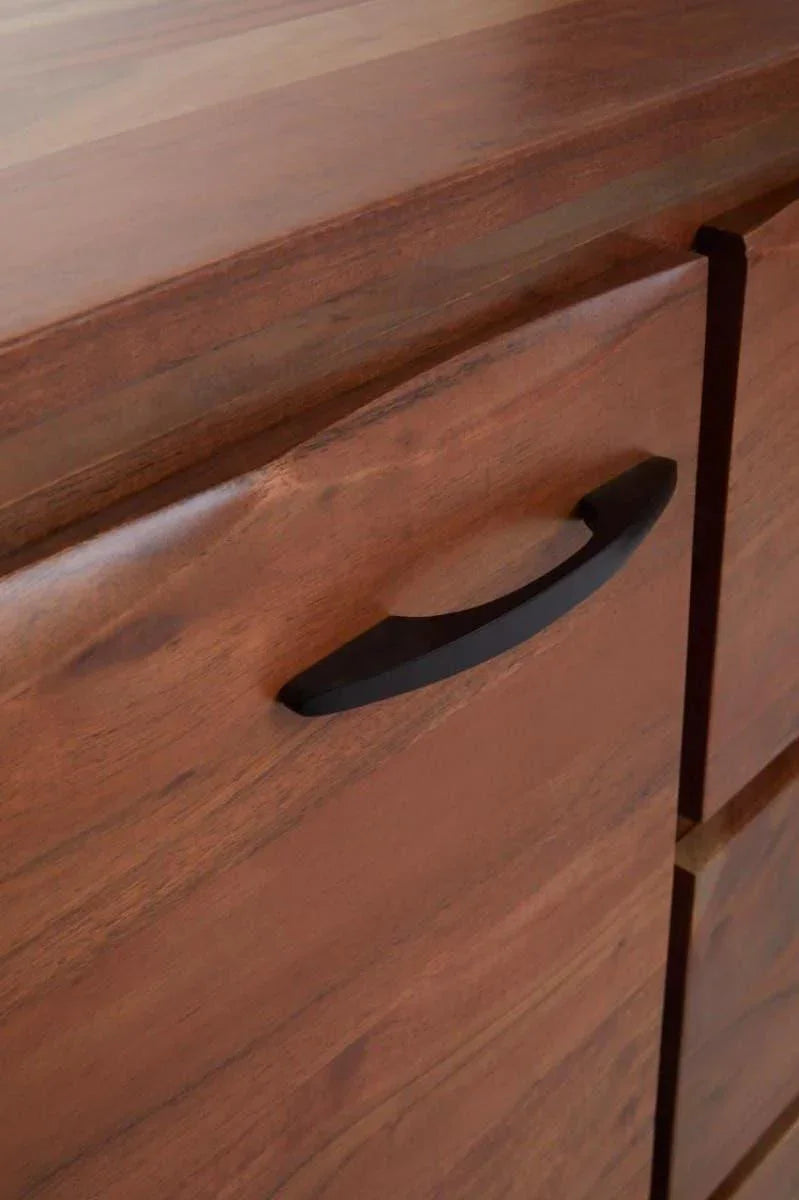 Closeup of wooden sideboard drawer with black metal handle and smooth finish