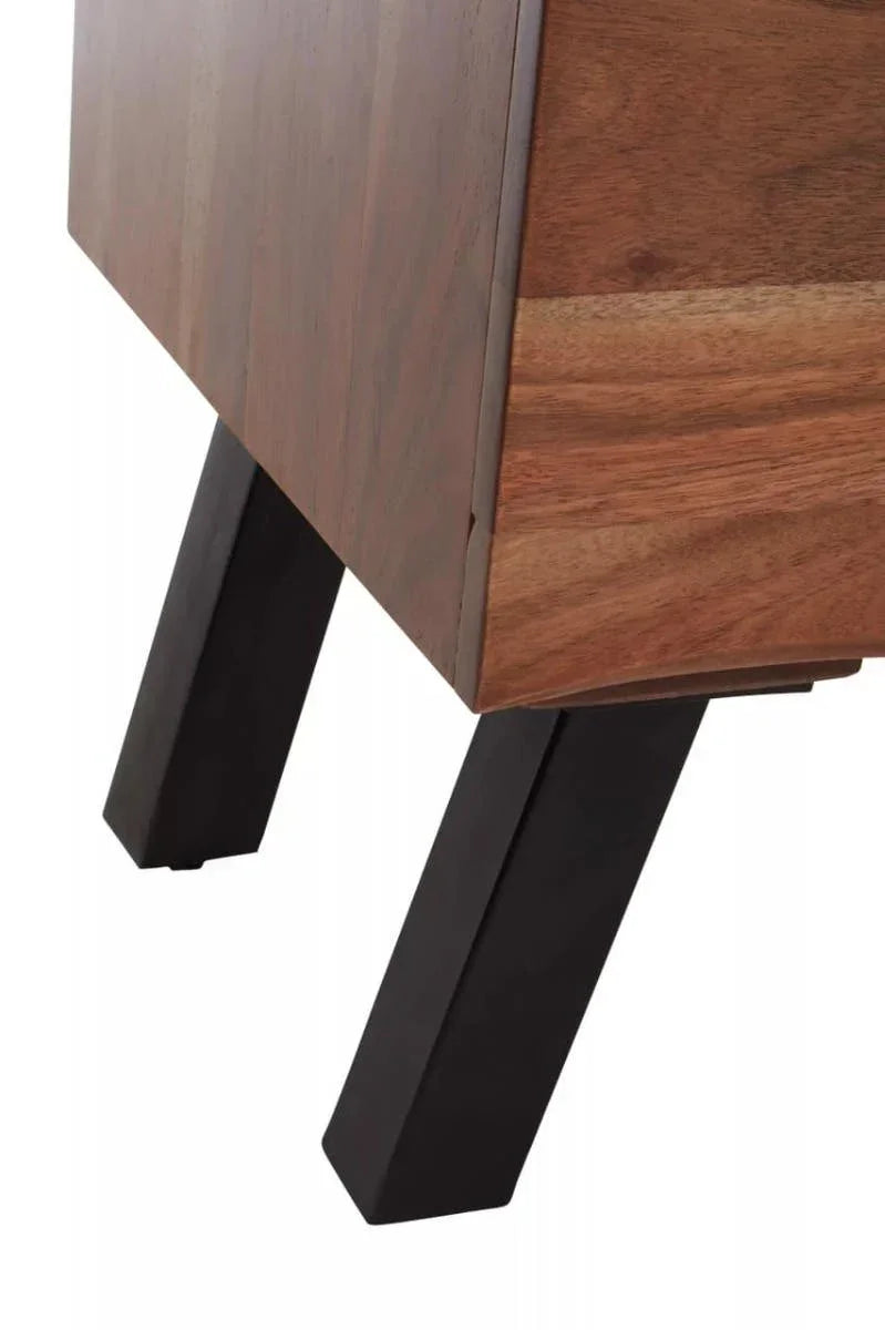 Closeup of wooden furniture leg with black angled base and natural wood grain finish