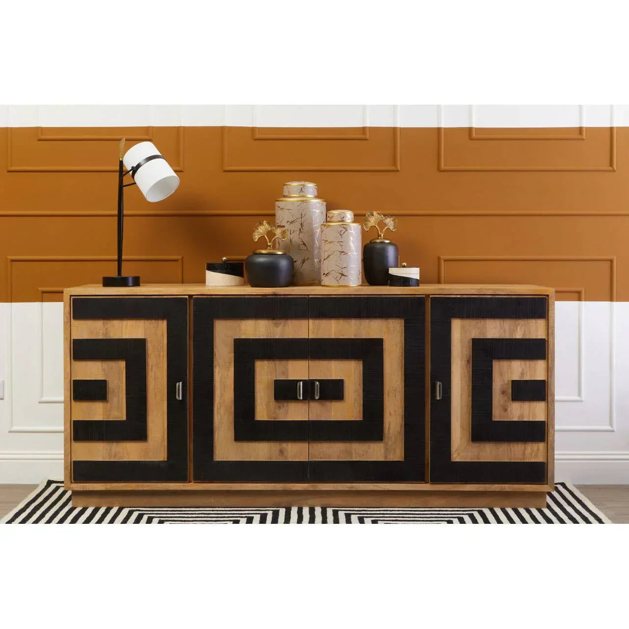 Geometric wood sideboard with black accents, decorative vases, and modern lamp on top