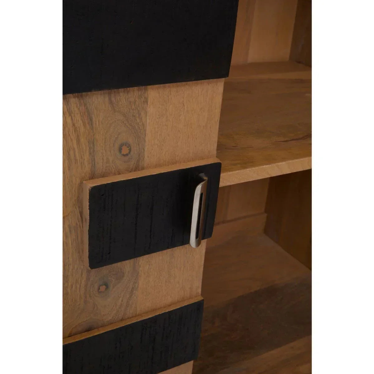 Wooden cabinet closeup showing black handle and shelf detail