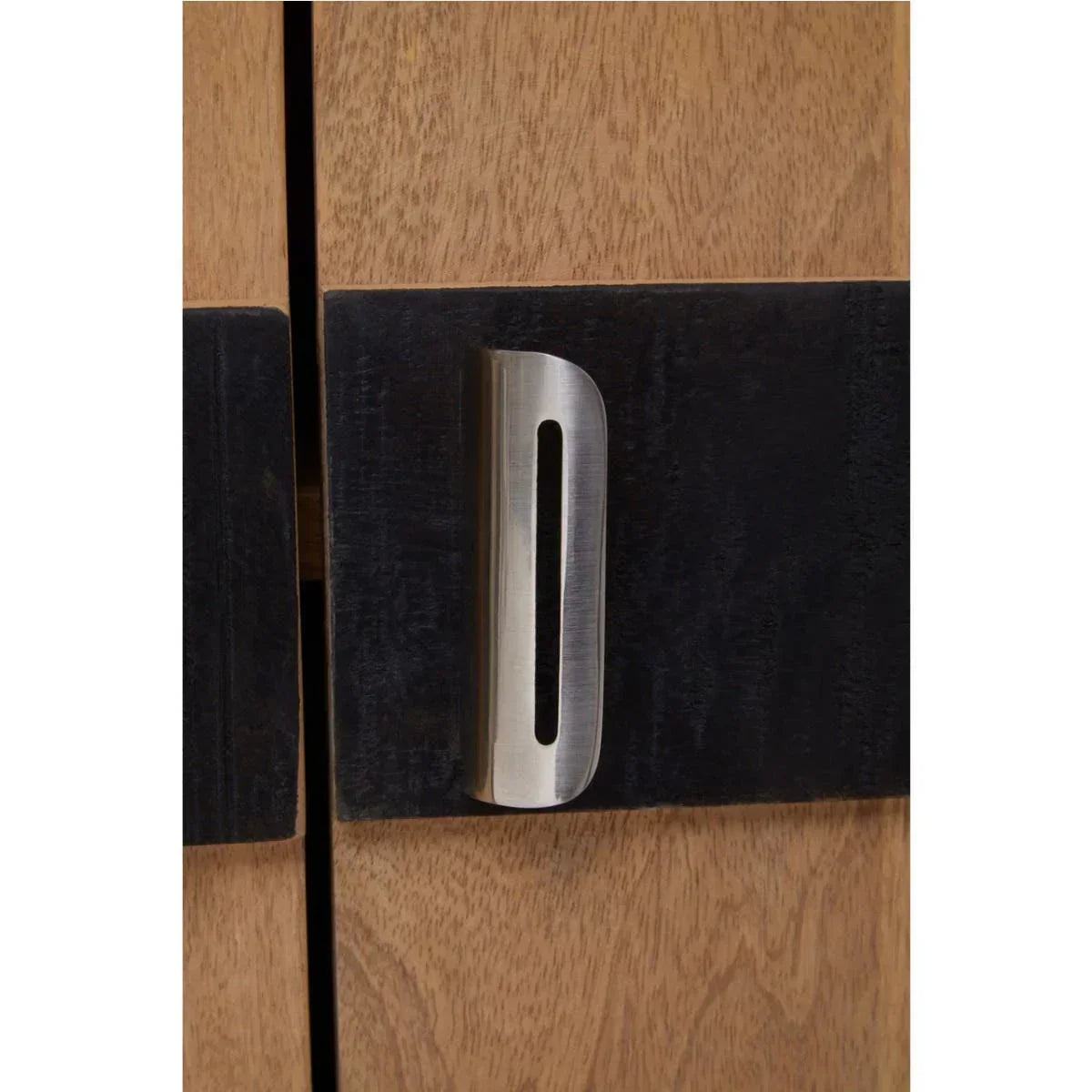 Close up of wood cabinet with black panel and brushed metal door handle