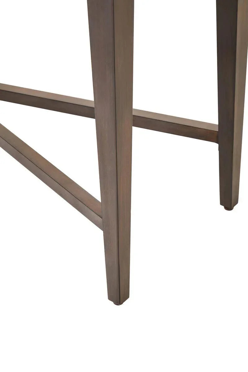 Close view of wooden dining table legs with crossbar support in brown finish