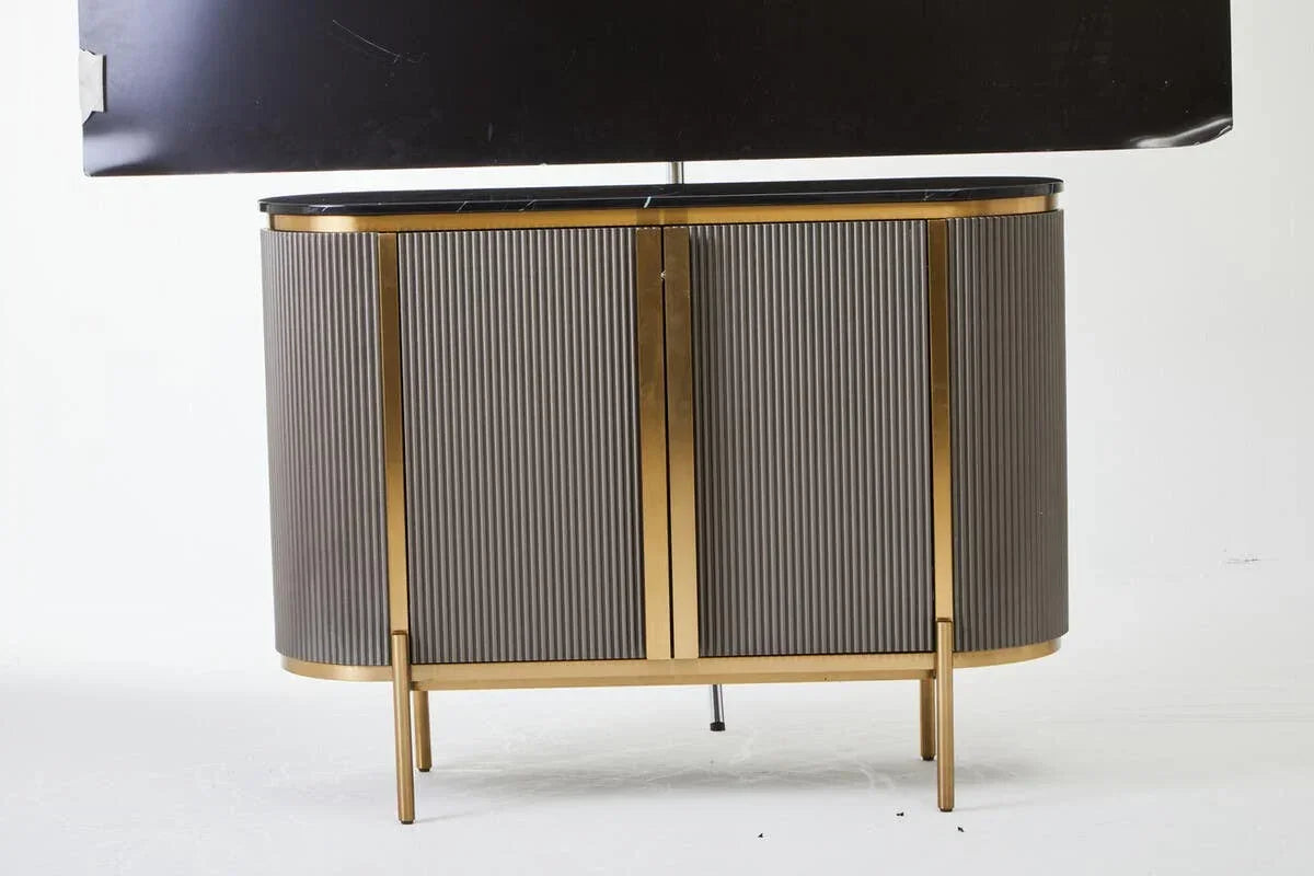 Modern sideboard with gold metal frame, ribbed grey doors, and black marble top