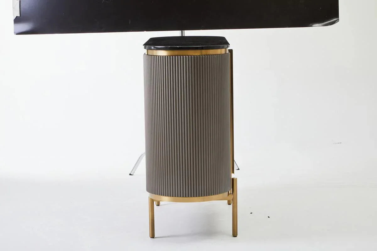 Brown ribbed dining table base with gold legs and black tabletop edge