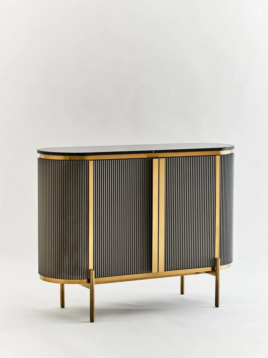 Gold and black sideboard cabinet with fluted doors and marble top on gold legs