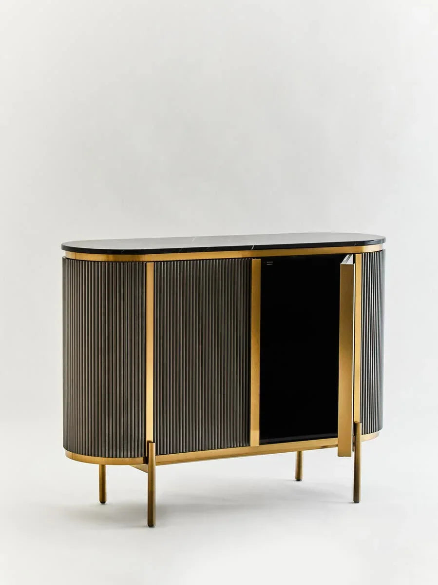 Black and gold sideboard cabinet with vertical fluted panels and open door on white background