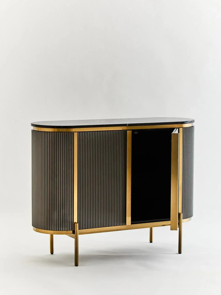 Modern sideboard with black fluted panels, gold frame, and marble top on white background