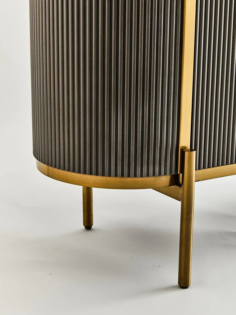 Close-up of ribbed wood sideboard with brass legs and trim on white background