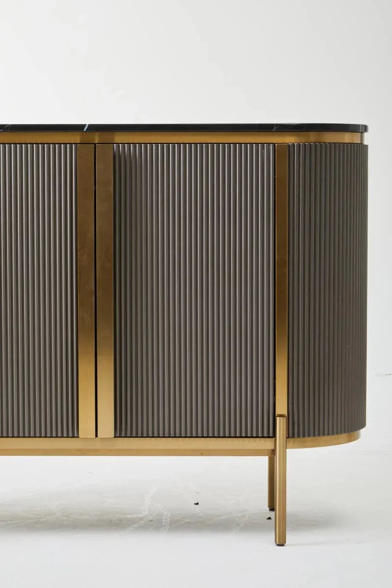 Modern sideboard with fluted doors, gold accents and black marble top on white background