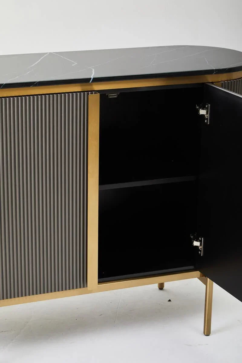 Sideboard with black marble top, gold frame, open door, and vertical ribbed panels