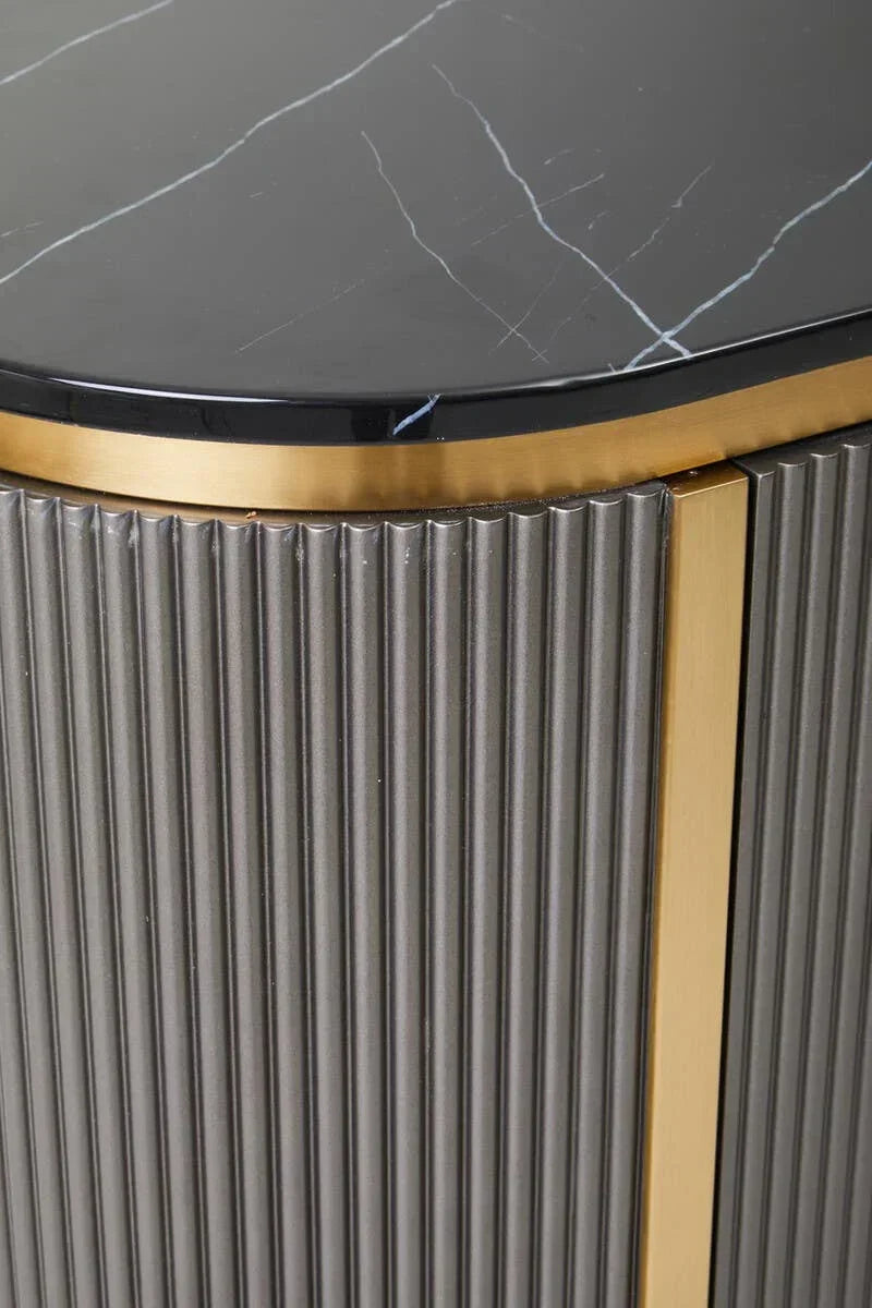 Close-up of black marble side table top with gold trim and ribbed grey panel