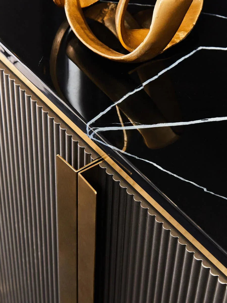 Black marble top sideboard with gold handles and ribbed cabinet doors