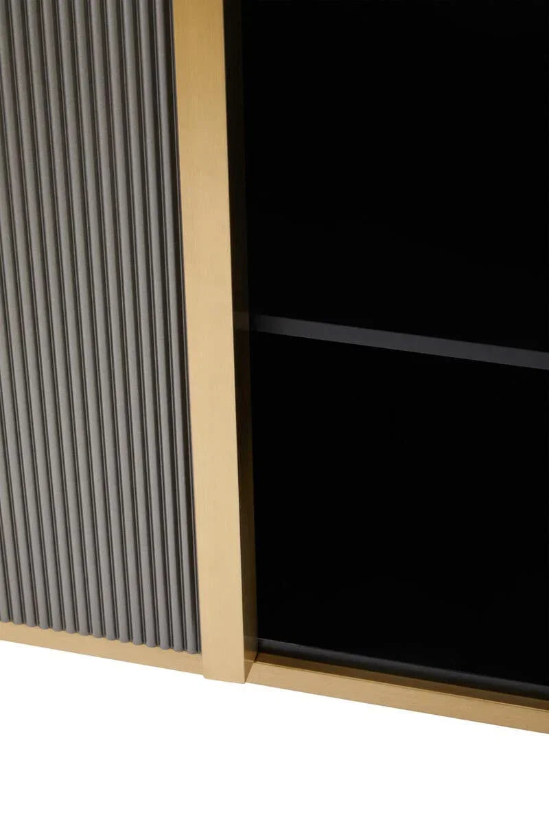 Detail of ribbed wood cabinet door with gold trim and black interior shelving