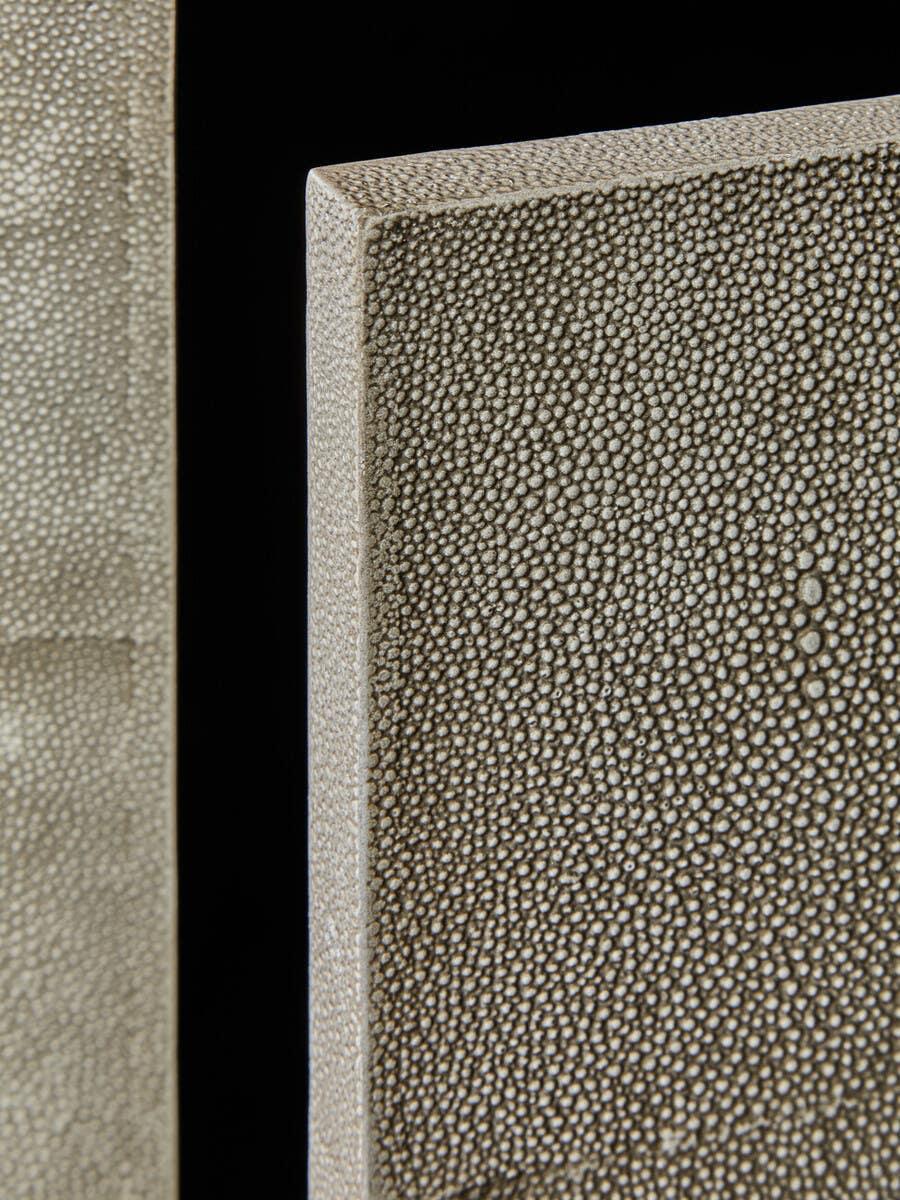Closeup of textured faux shagreen furniture panel in neutral beige finish