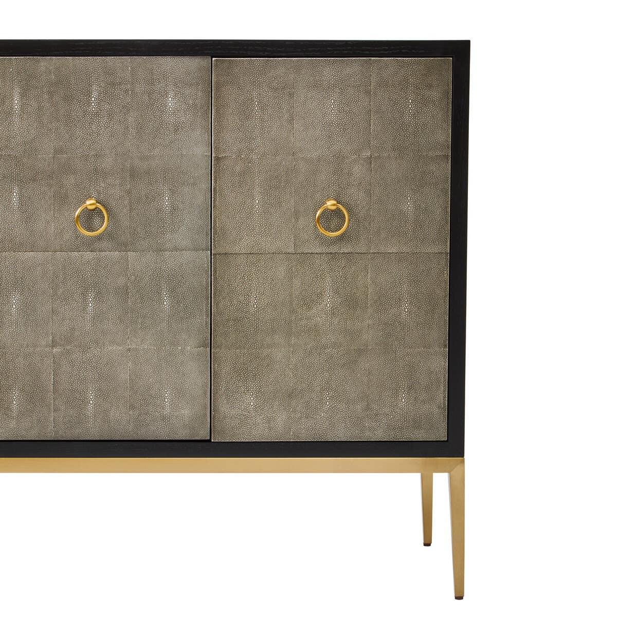Grey sideboard cabinet with textured doors, gold handles, and metal legs