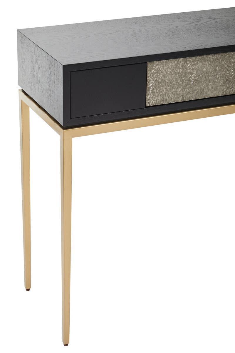 Modern console table with black wood top, gold metal legs, and textured drawer front
