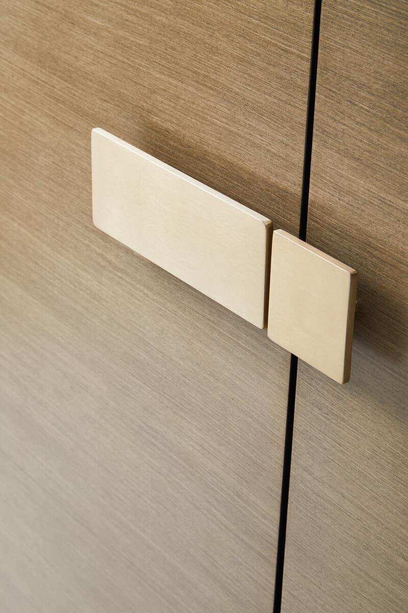 Closeup of modern wood cabinet door with rectangular handles
