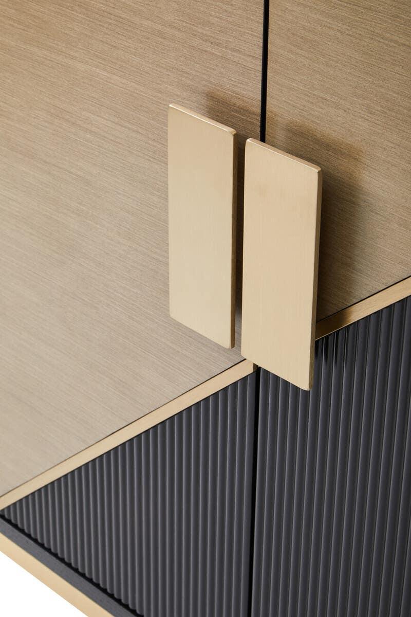 Modern sideboard cabinet with gold handles and textured black panel detailing
