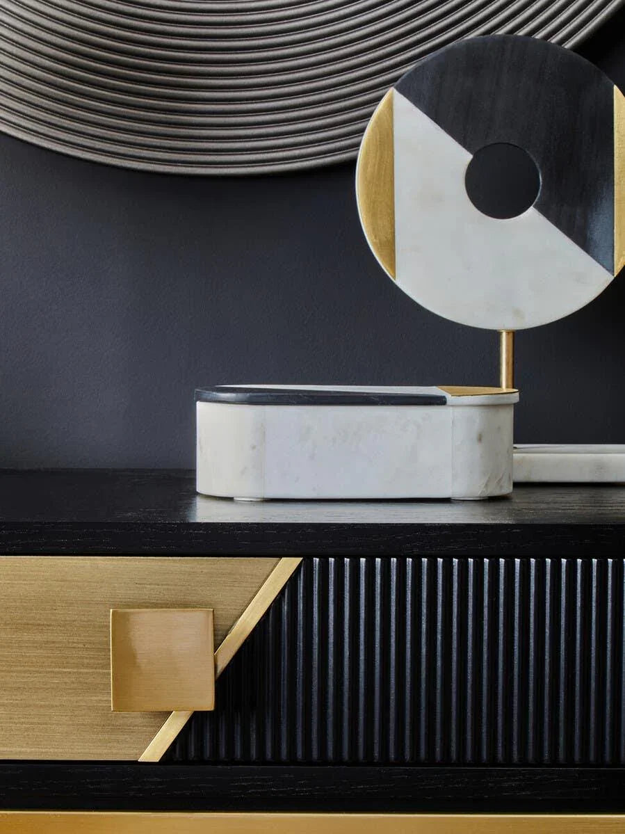 Black and gold sideboard with geometric marble decor and ribbed drawer detail