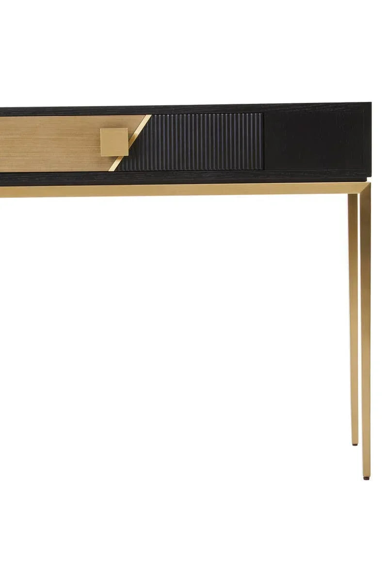 Black and gold console table with modern angular legs and textured drawer front