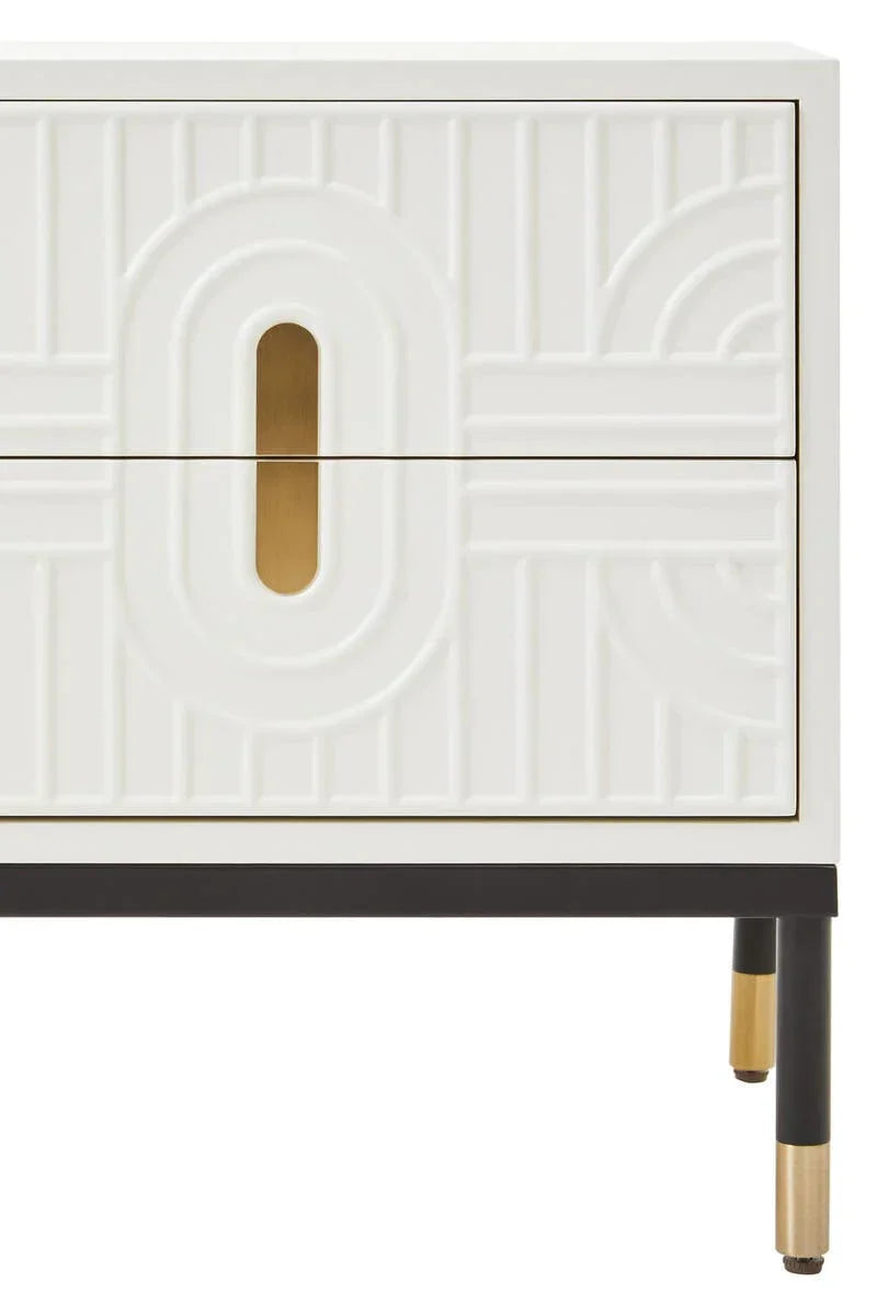 White bedside table with gold handles, embossed drawer fronts, and metal legs