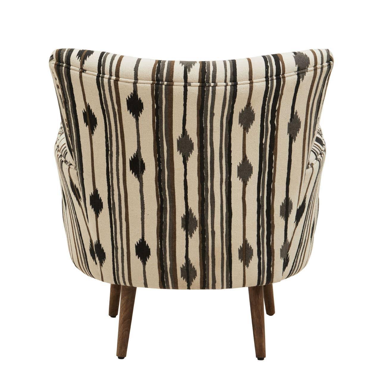 Patterned accent chair with vertical black and brown stripes, rear view, wooden legs