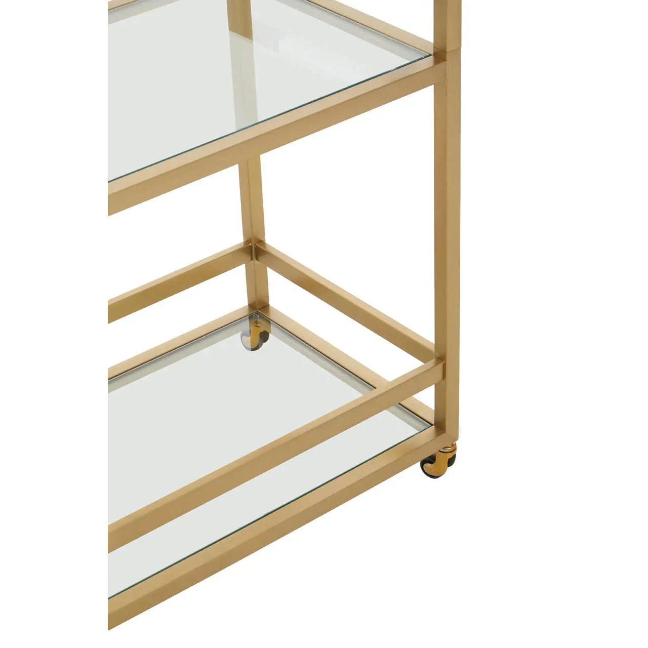 Gold metal bar cart with glass shelves and caster wheels, close-up of lower section
