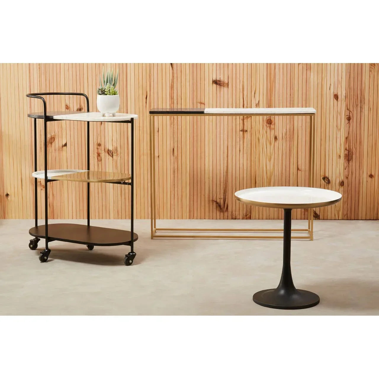 Marble top side table and serving trolley with black metal frames against wooden wall