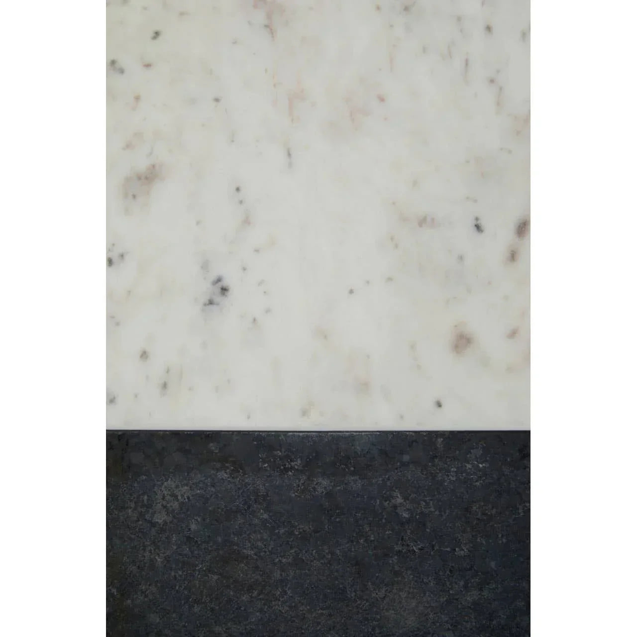 White marble tabletop with black stone edge, close-up of surface texture