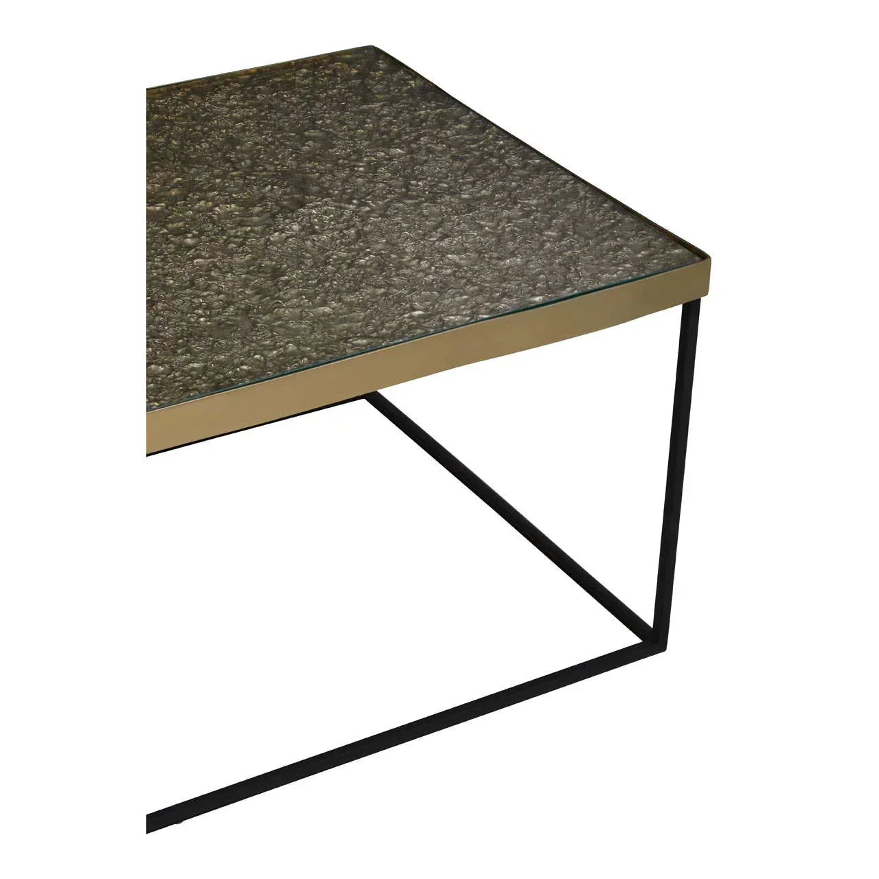 Glass top coffee table with gold trim and black metal legs, close-up corner view