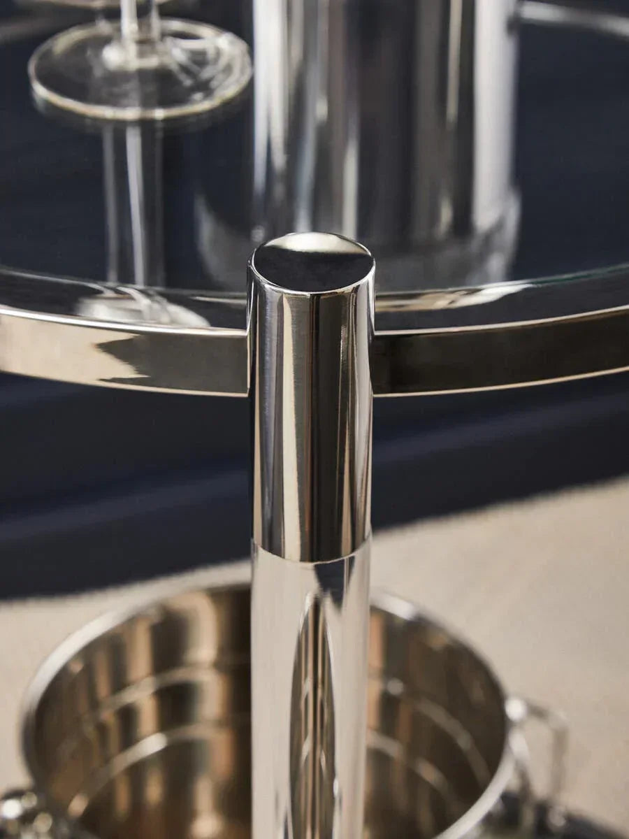 Close view of chrome bar cart frame with glass top and wine bucket underneath