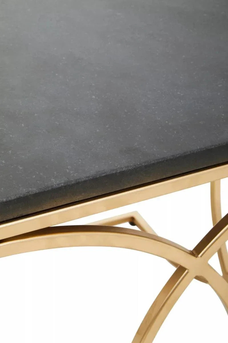 Black stone dining table top with gold metal frame, close-up corner view