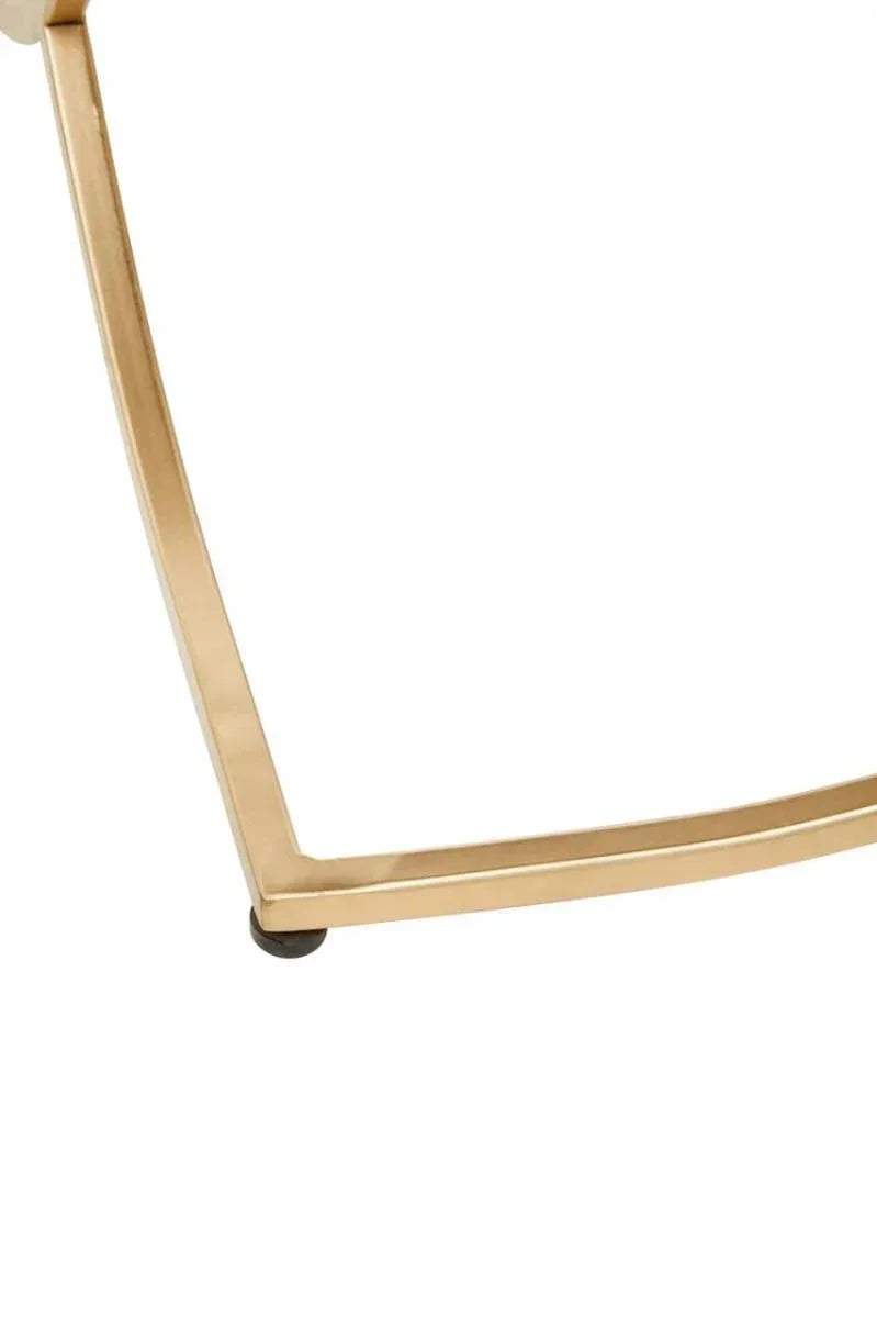 Close up of gold metal table leg with black floor protector