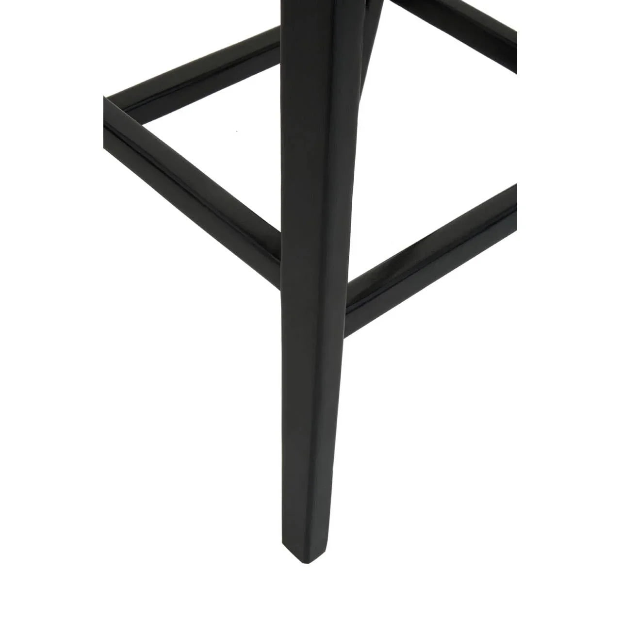 Black metal furniture leg with support bar, close-up view of modern stool base