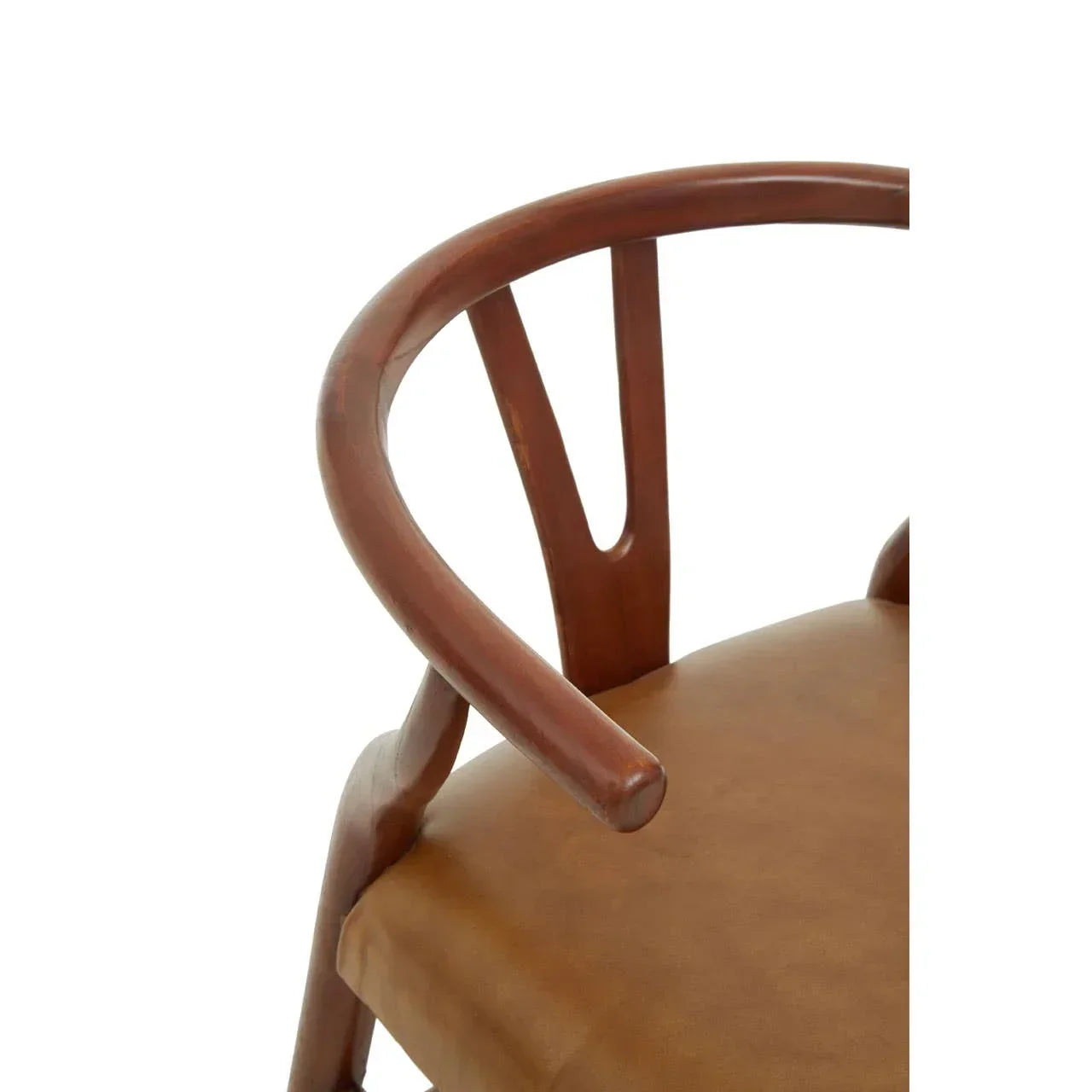 Walnut wood dining chair with curved backrest and tan leather seat, close up view