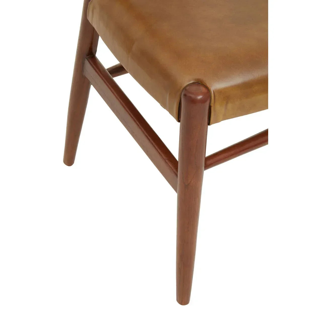 Close-up of dining chair with tan leather seat and wooden legs