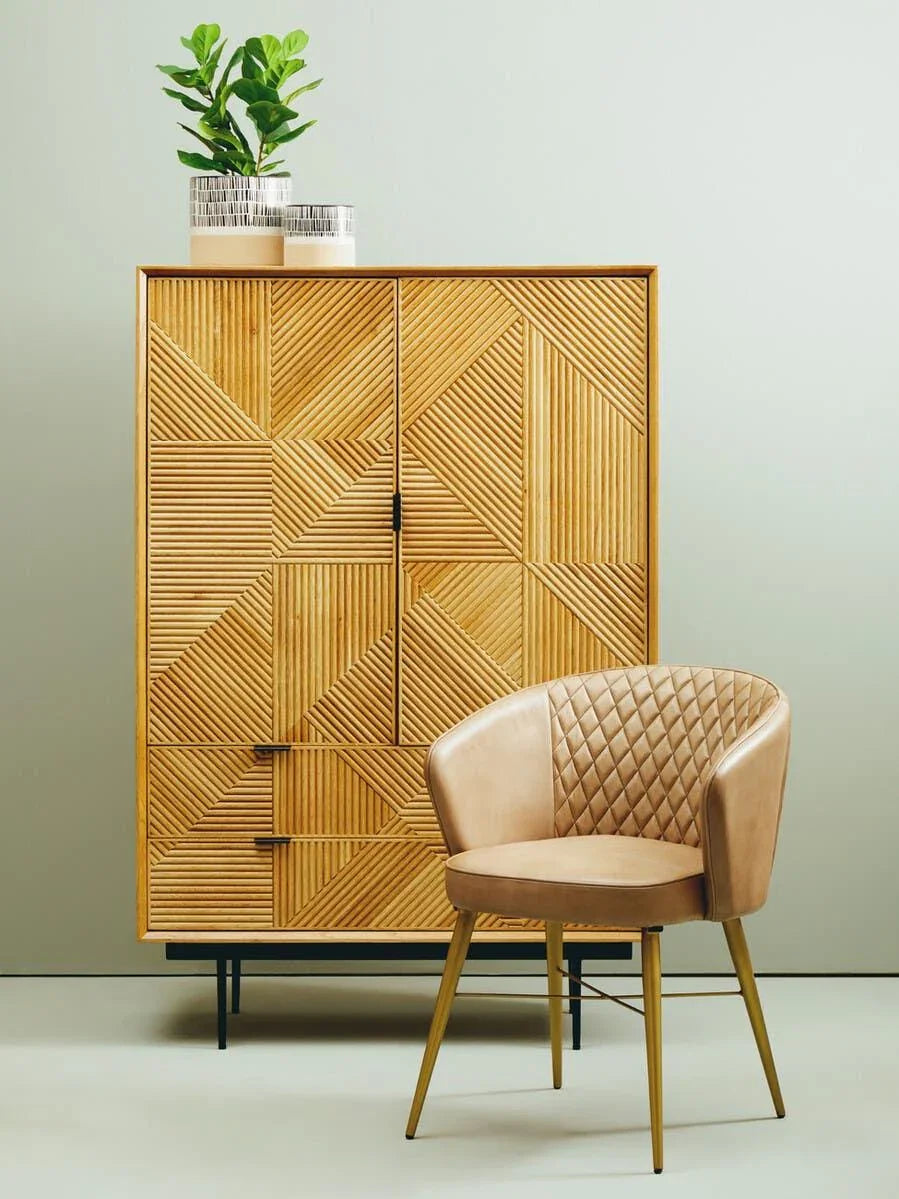 Geometric wood sideboard with metal legs and tan quilted dining chair in modern room