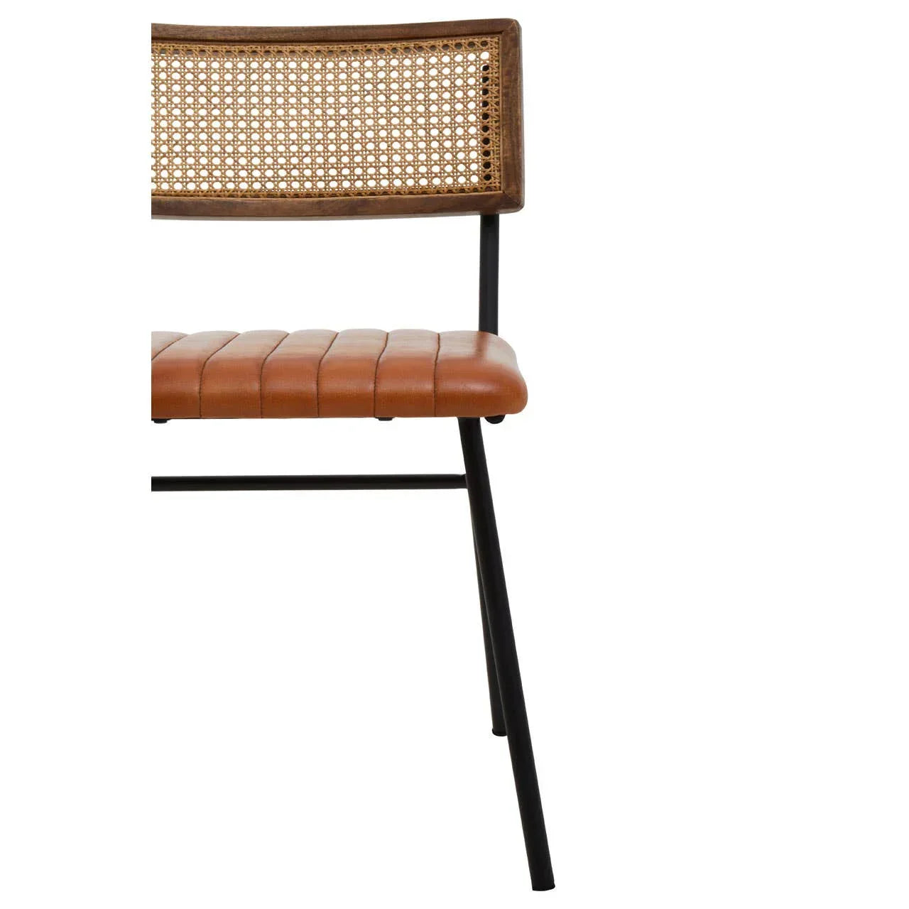 Rattan back dining chair with tan leather seat and black metal legs, side angle view